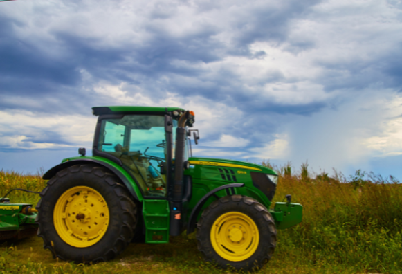 Green tractor in a field