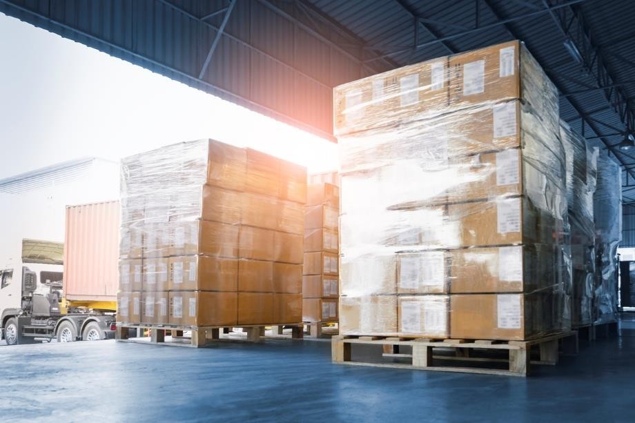 Wrapped pallets of boxes at a warehouse loading dock